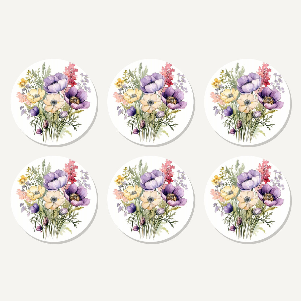 Flat lay of the lilac & cream anemone bouquet artwork on six round coasters