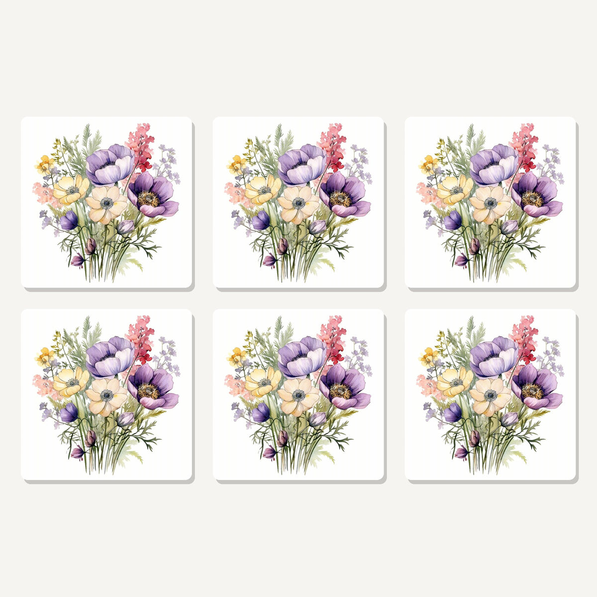 Flat lay of the lilac & cream anemone bouquet artwork on six square coasters