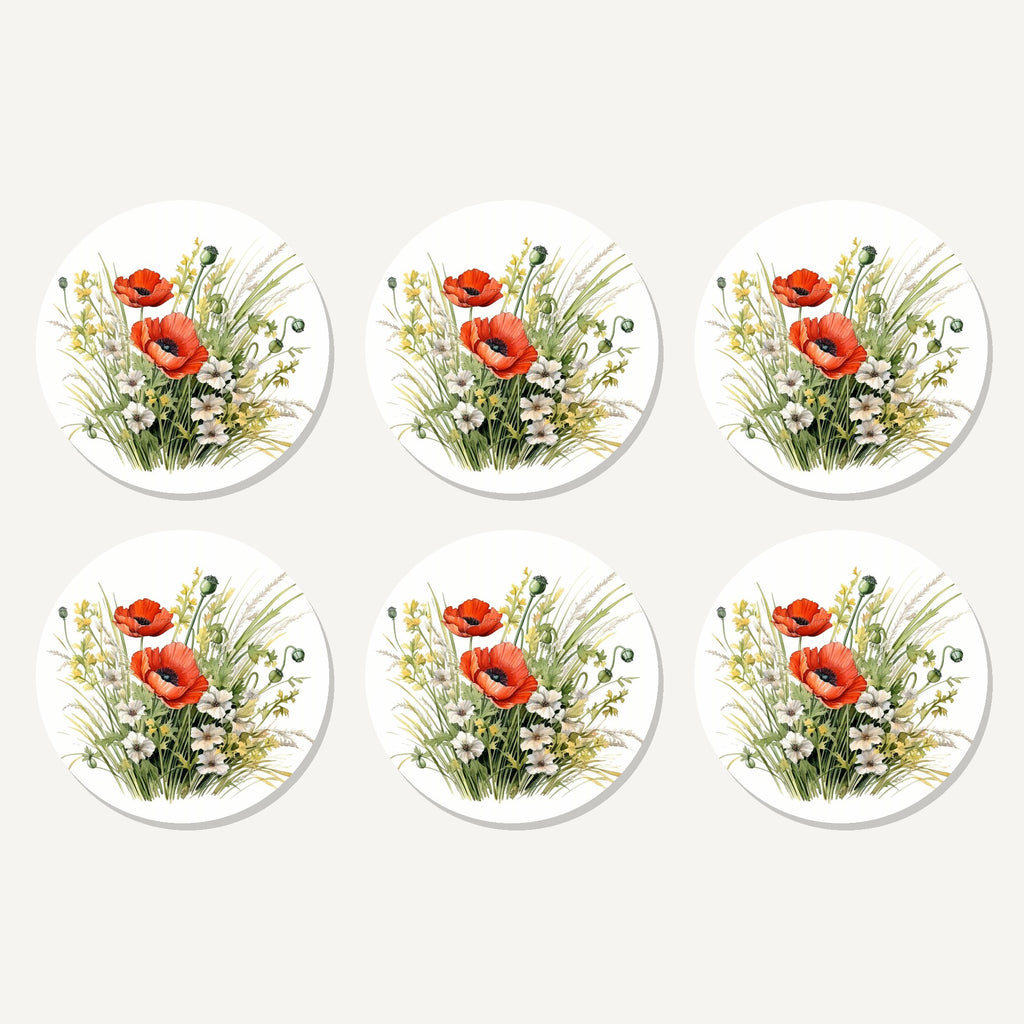 Flat lay of the red poppy & meadow grass artwork on six round coasters