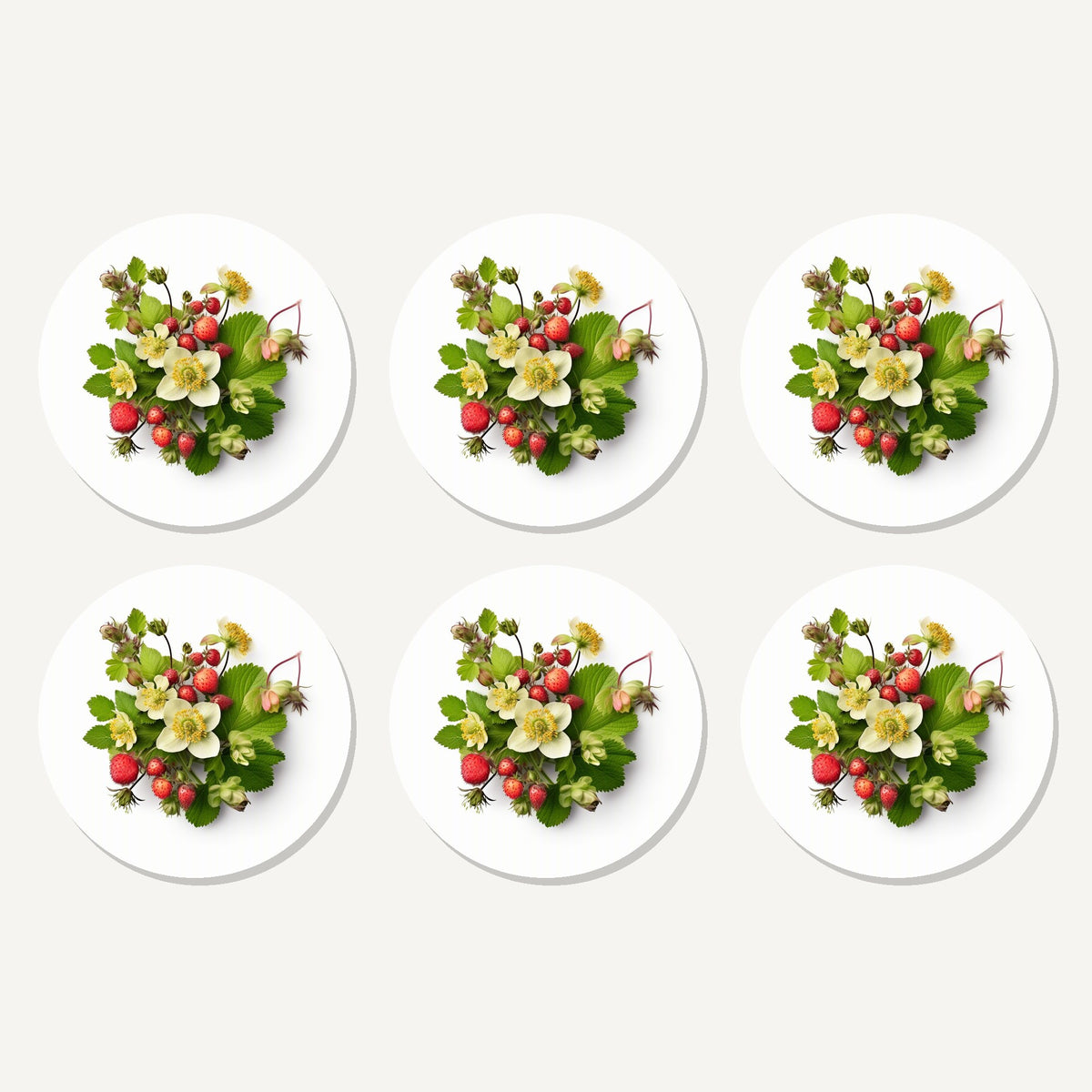 Flat lay of the strawberries & blossom artwork on six round coasters