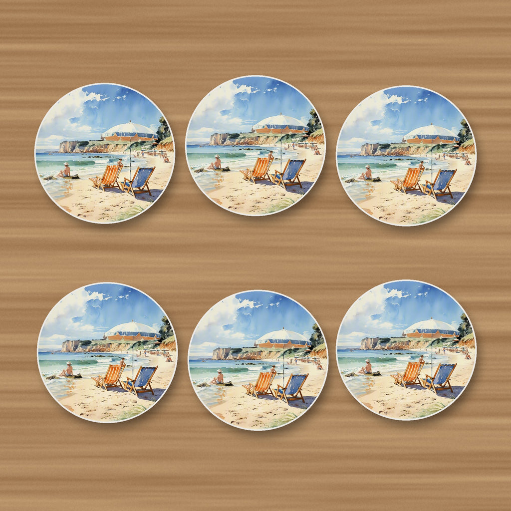 Watercolour Beach Deckchairs & Cliffs round ceramic coasters, set of 6, on an oak coffee table