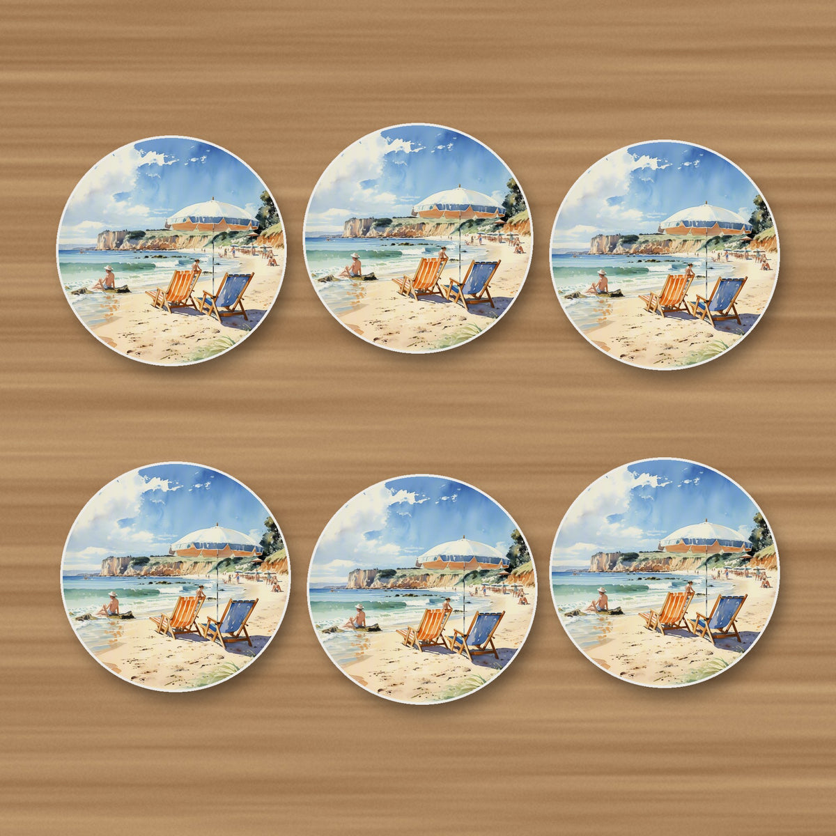 Watercolour Beach Deckchairs & Cliffs round ceramic coasters, set of 6, on an oak coffee table