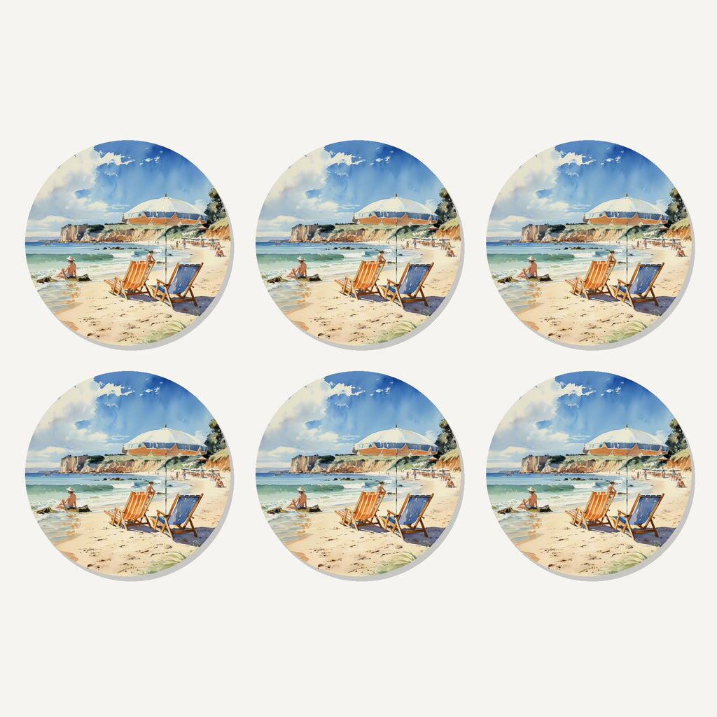 Flat lay of the watercolour beach deckchairs & cliffs artwork on six round coasters