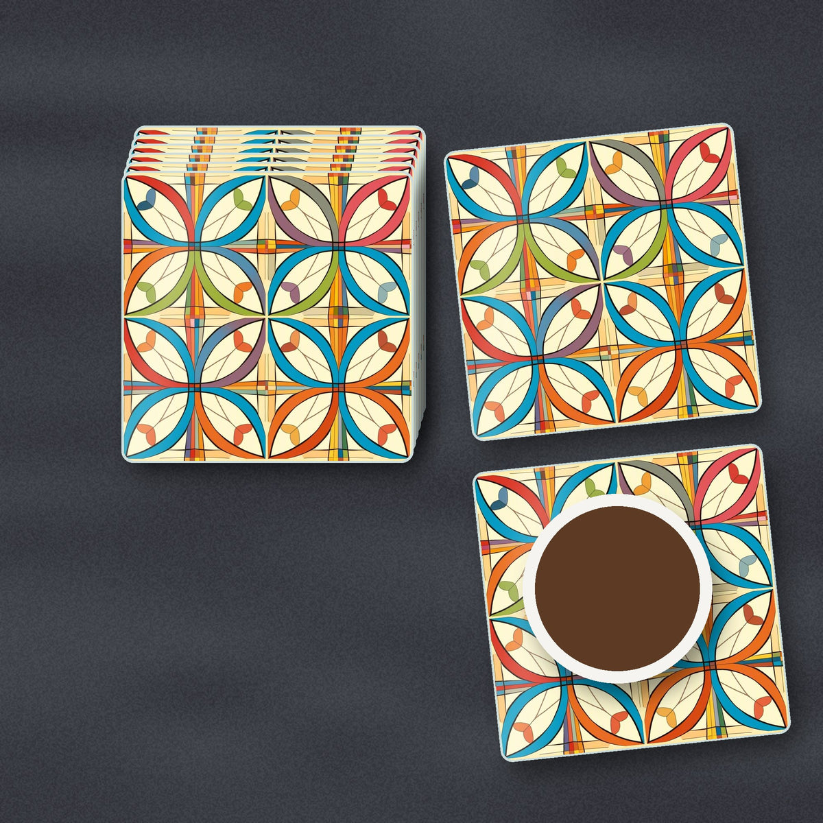 Retro Quatrefoil Tile Pattern square glass coasters stacked on a slate kitchen worktop