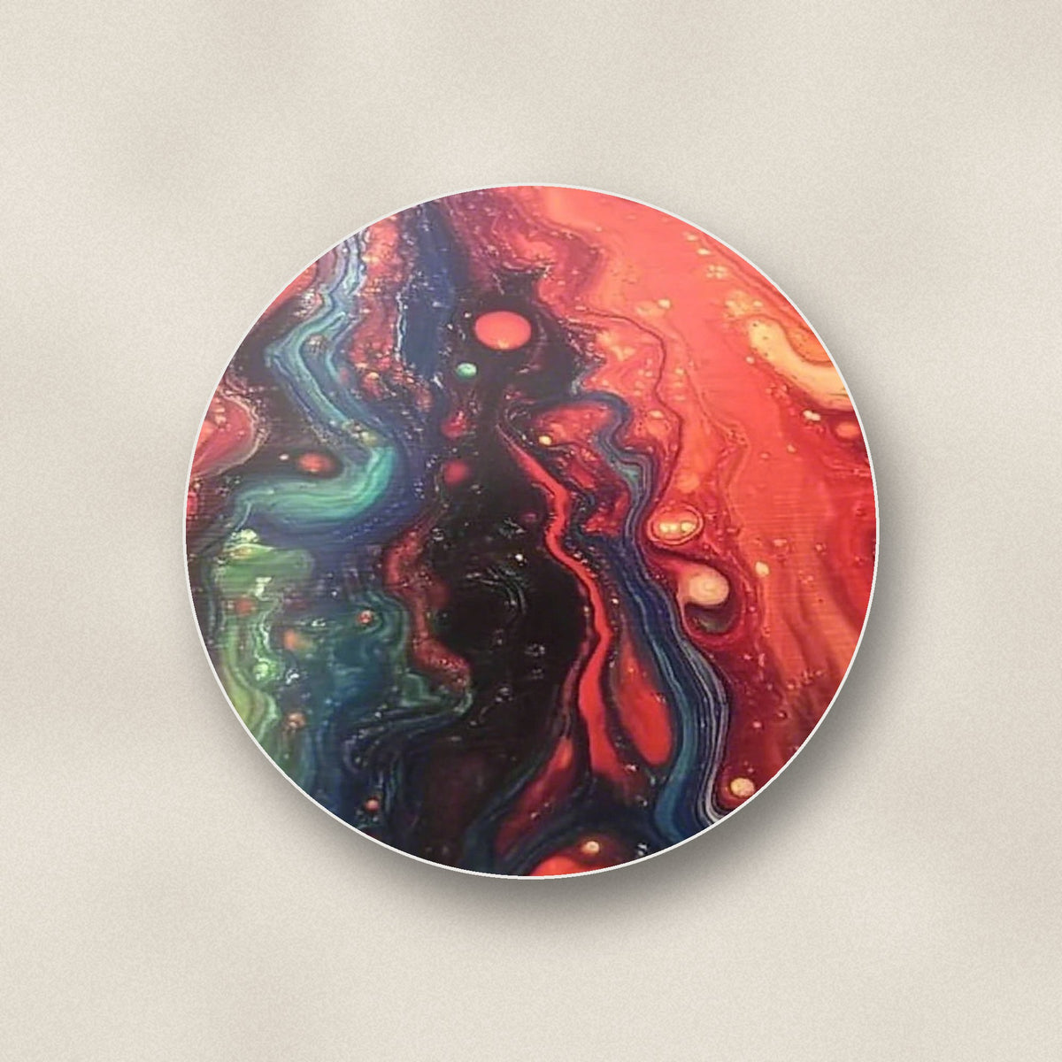 Close-up of one red & teal fluid art round ceramic coaster, flat UV print