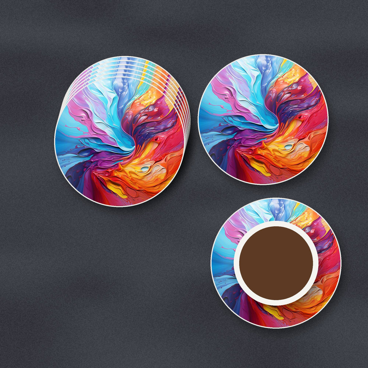 Rainbow Paint Swirl round ceramic coasters stacked on a slate kitchen worktop