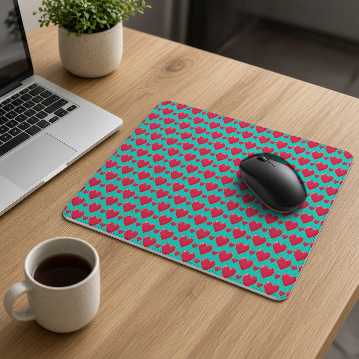 Heart Bubble Grid vegan leather mouse mat on an oak desk with a laptop, mouse and coffee