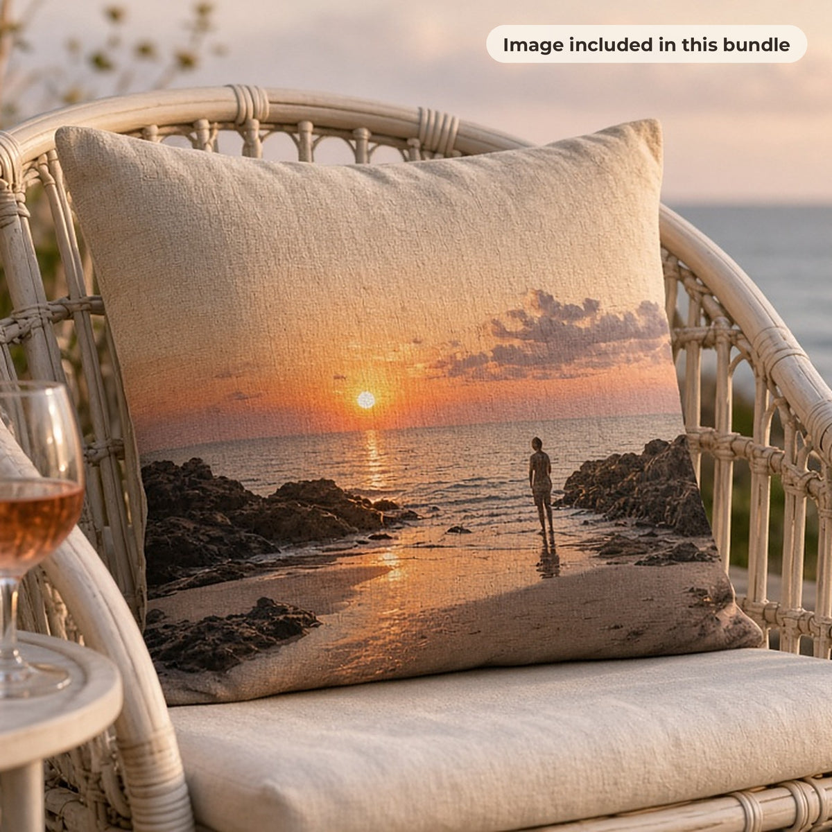 Landscape & Beach Art Collection: Linen cushion printed with a sunset over a rocky beach on a rattan chair on a seaside terrace (image from this bundle)