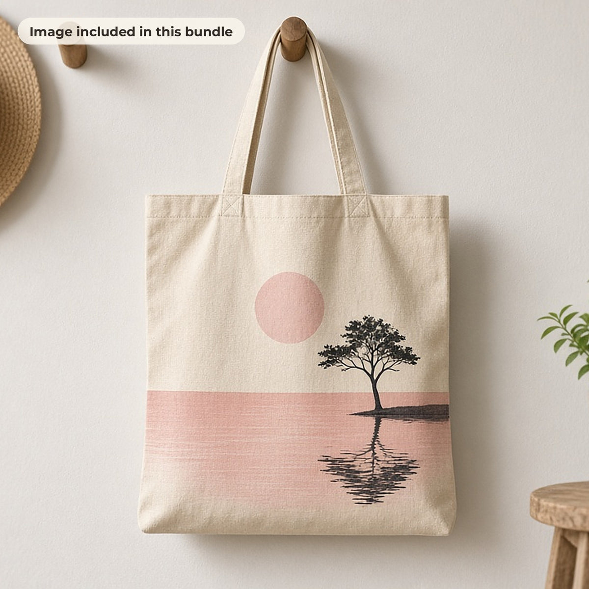 Minimalist Art Collection: Canvas tote bag printed with a minimalist pink sunset and lone tree, hanging on a peg beside a straw hat (image from this bundle)