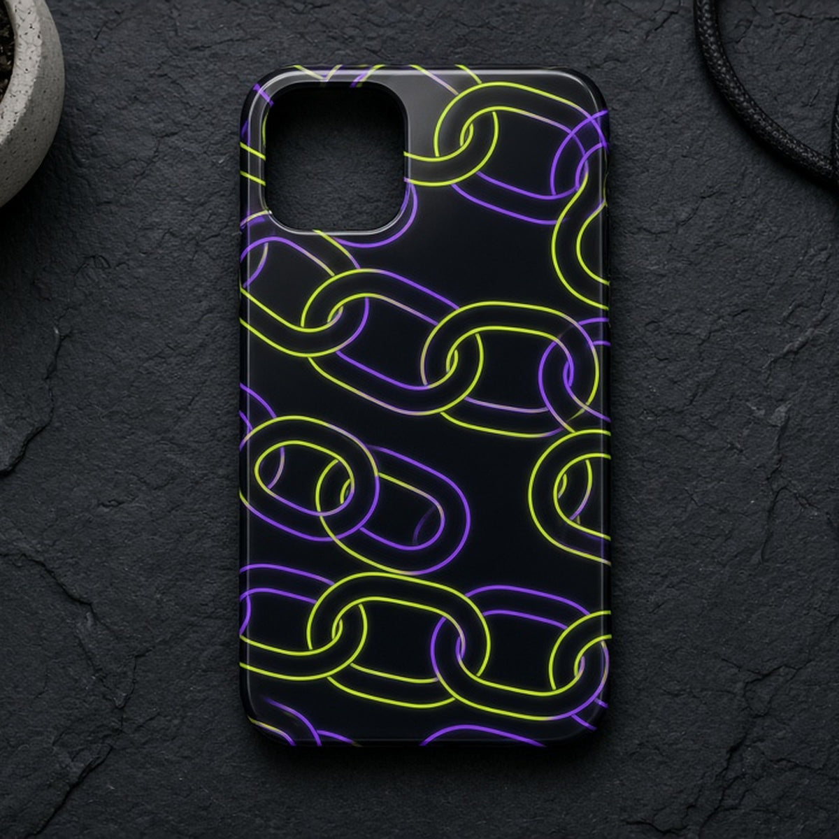 Neon lime and purple chain-link pattern printed flat on a phone case on dark slate, made with prompt #126