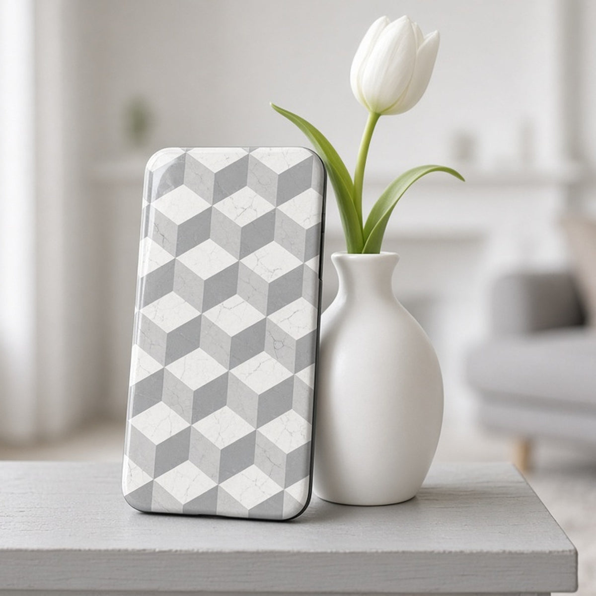 White marble isometric cube pattern printed flat on a phone case on a grey shelf, made with prompt #76