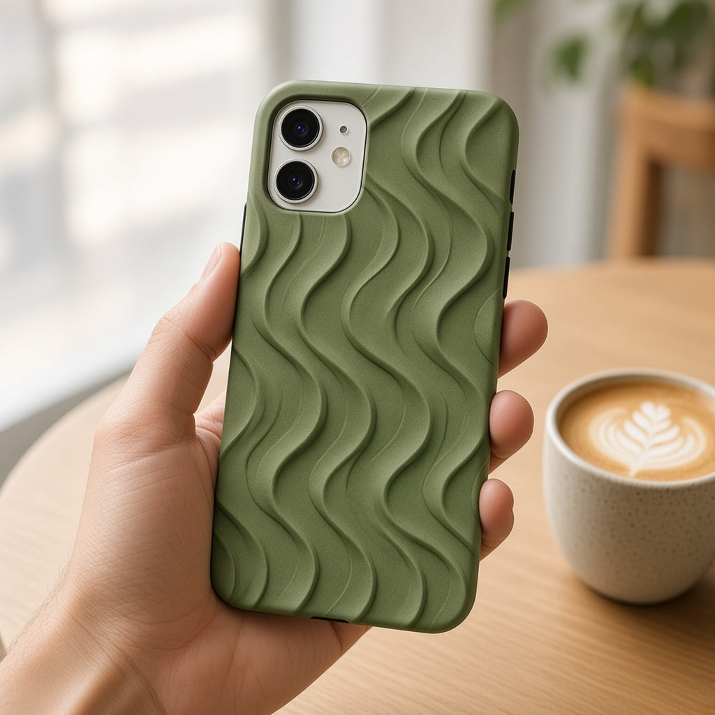 Hand holding a phone in an olive fine flowing waves relief case in a café with a latte, made with prompt #6