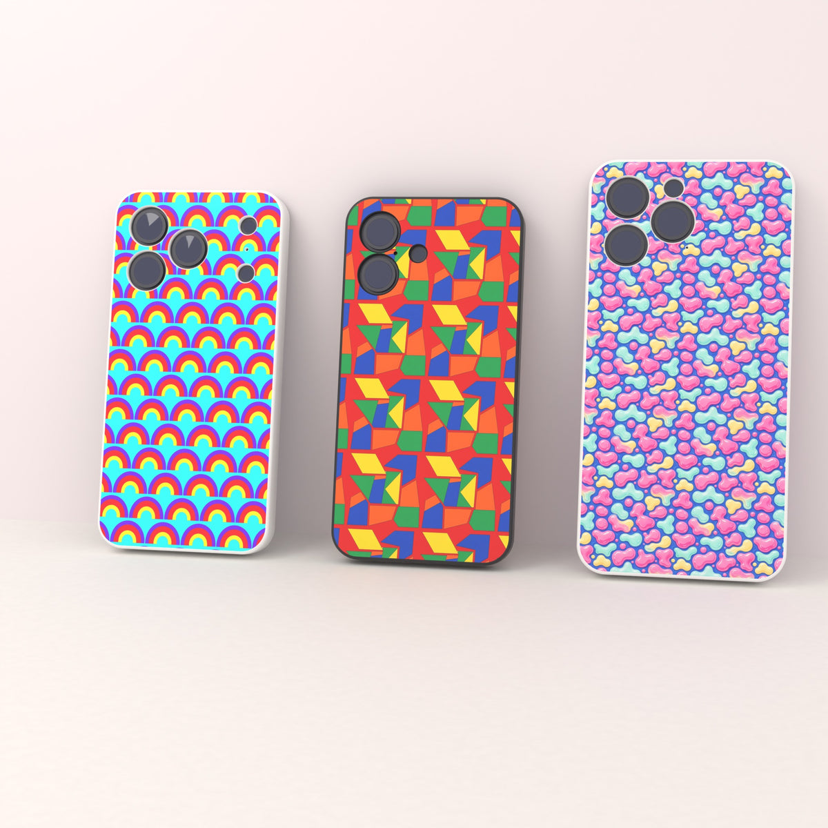 UV printed (back panel only): three phone cases with different back-panel artwork designs standing in a row, plain sides, clean camera cut-outs.