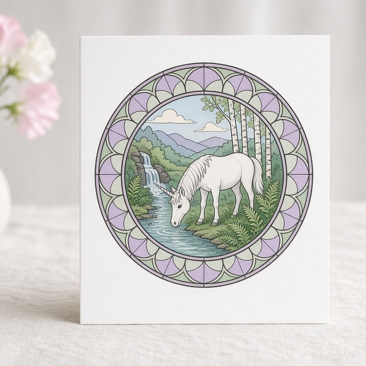Rose-window woodland scene of a unicorn drinking from a stream printed flat on a greeting card, made with prompt #47
