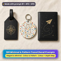 Three UV-printed travel accessories on cream linen: a black leather luggage tag with a gold fine-line compass rose, a white key ring with a terrazzo suitcase and a black passport cover with a gold paper plane and looping route, made with prompt #1 + #51 + #15