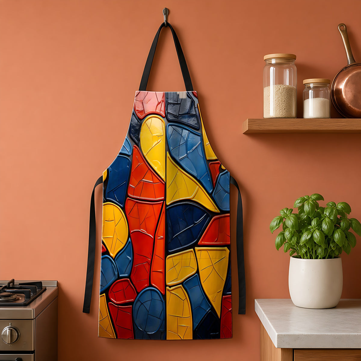 Bold Mosaic Glass Apron hanging on a terracotta kitchen wall