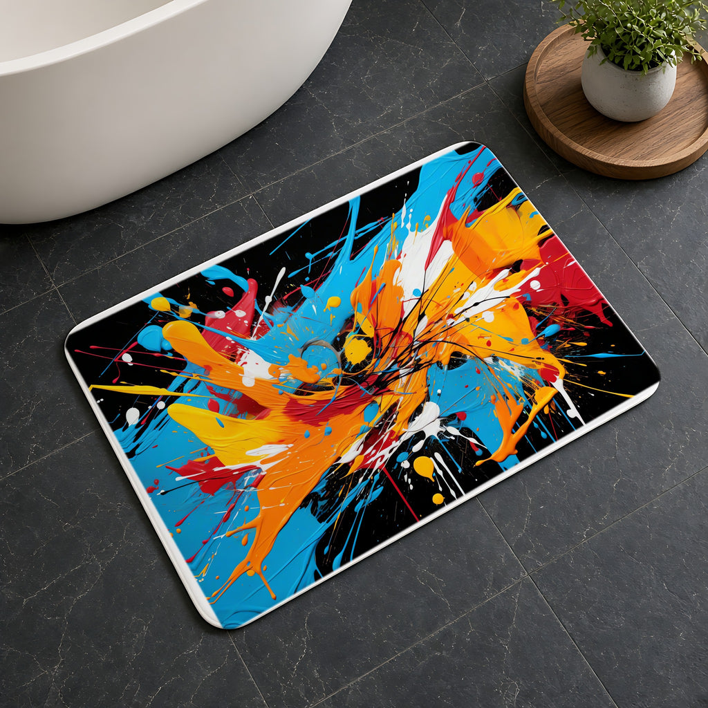 Electric Paint Splash Bath Mat on a dark slate floor beside a bath