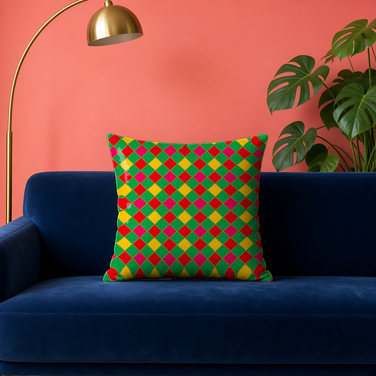Jewel Harlequin Check faux suede cushion in the Festive Jewel Bright palette, on a navy velvet sofa against a coral wall