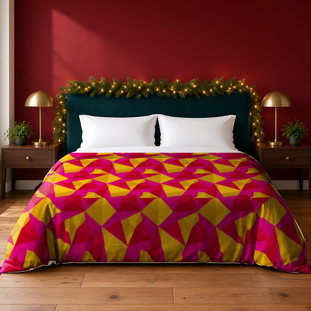 Faceted Gold Panels cotton duvet cover in the Festive Jewel Bright palette, on a bed with a green headboard in a festive bedroom with pine garland and fairy lights