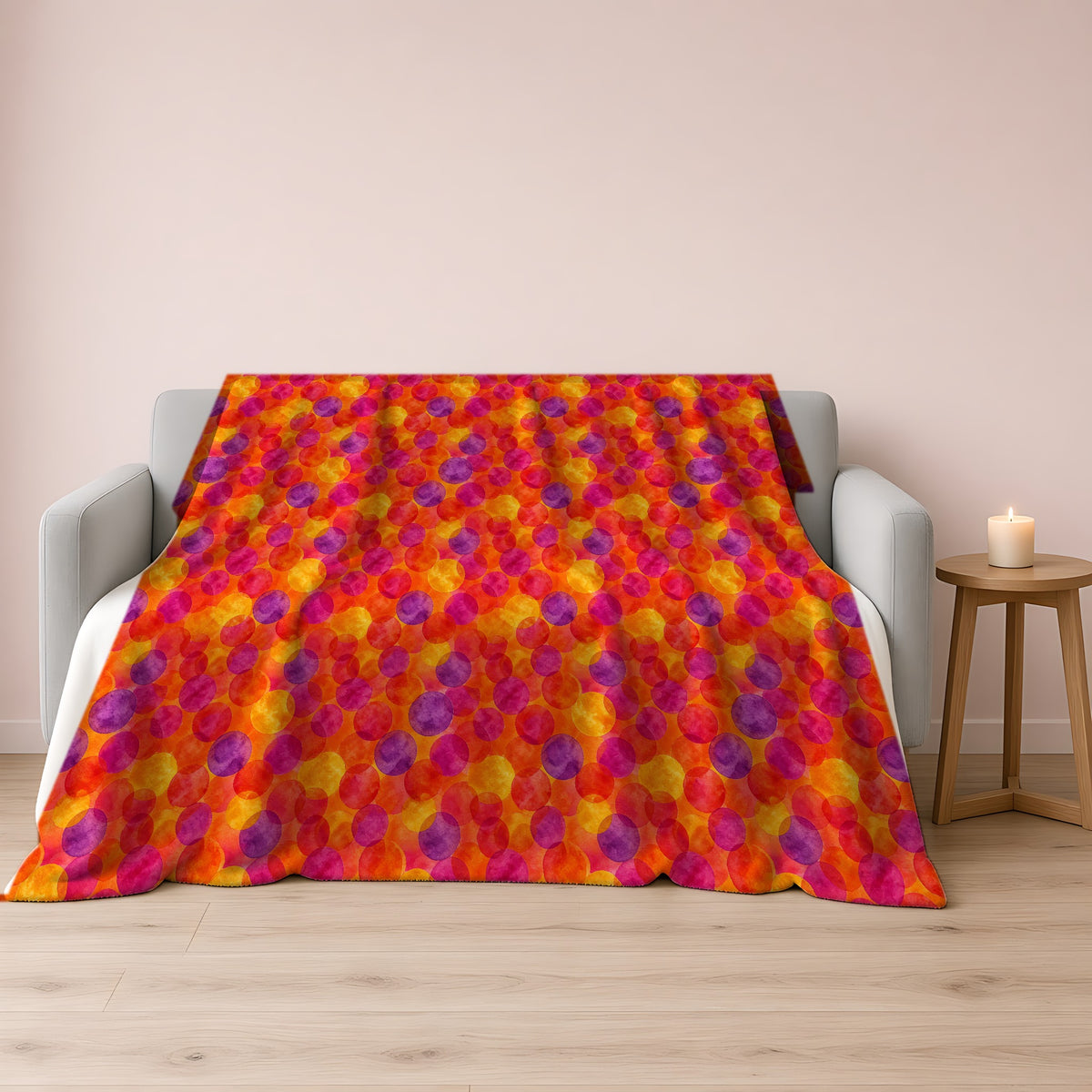 Glaze Circle Overlaps Sherpa Fleece Blanket draped over a grey sofa