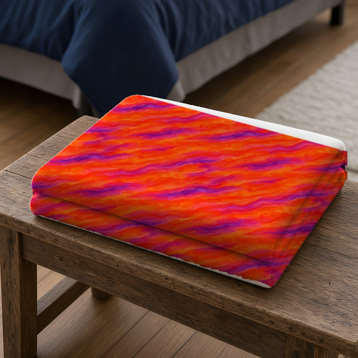 Wash Ribbon Drift Sherpa Fleece Blanket folded on a wooden bench