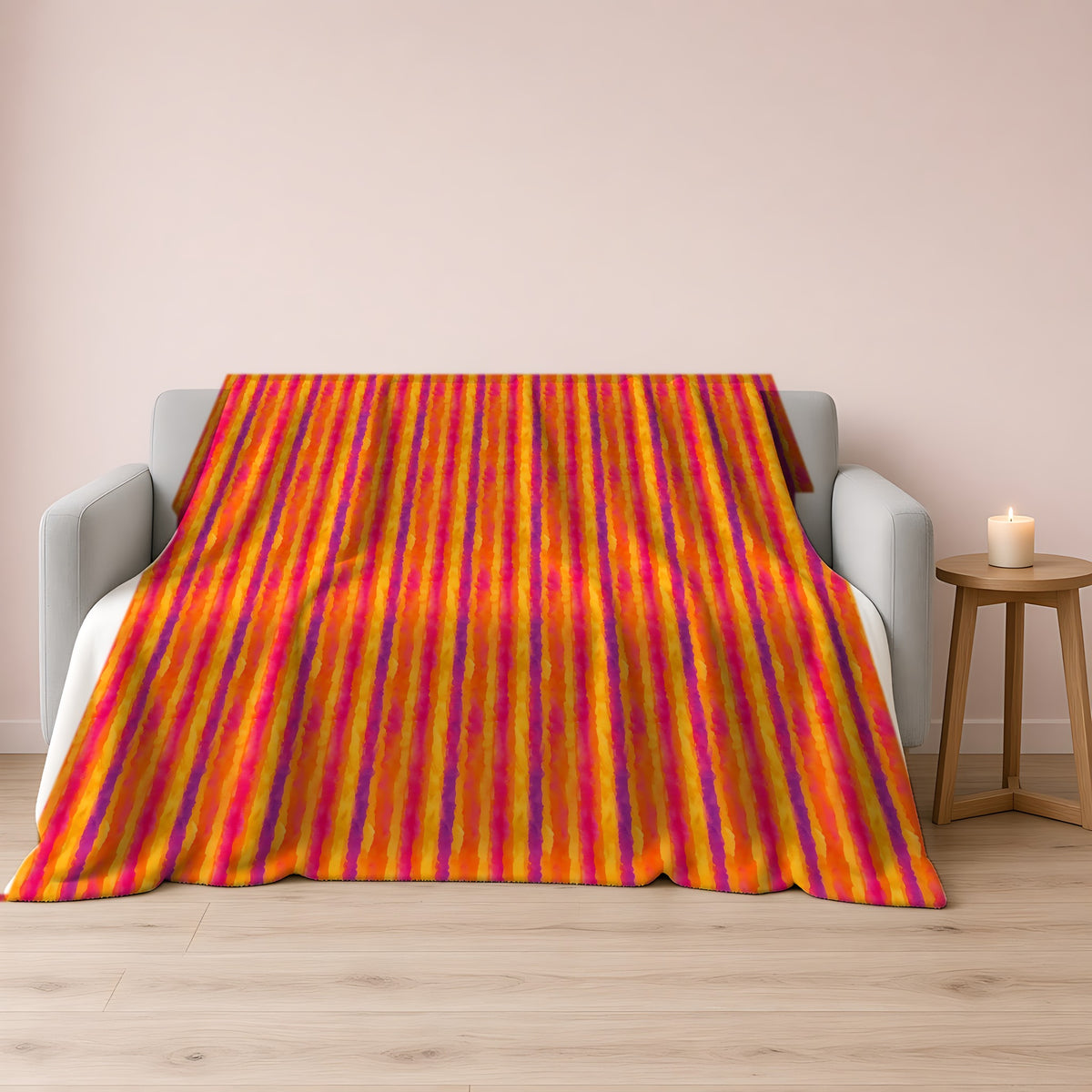 Bleed Stripe Ombre Sherpa Fleece Blanket draped over a grey sofa