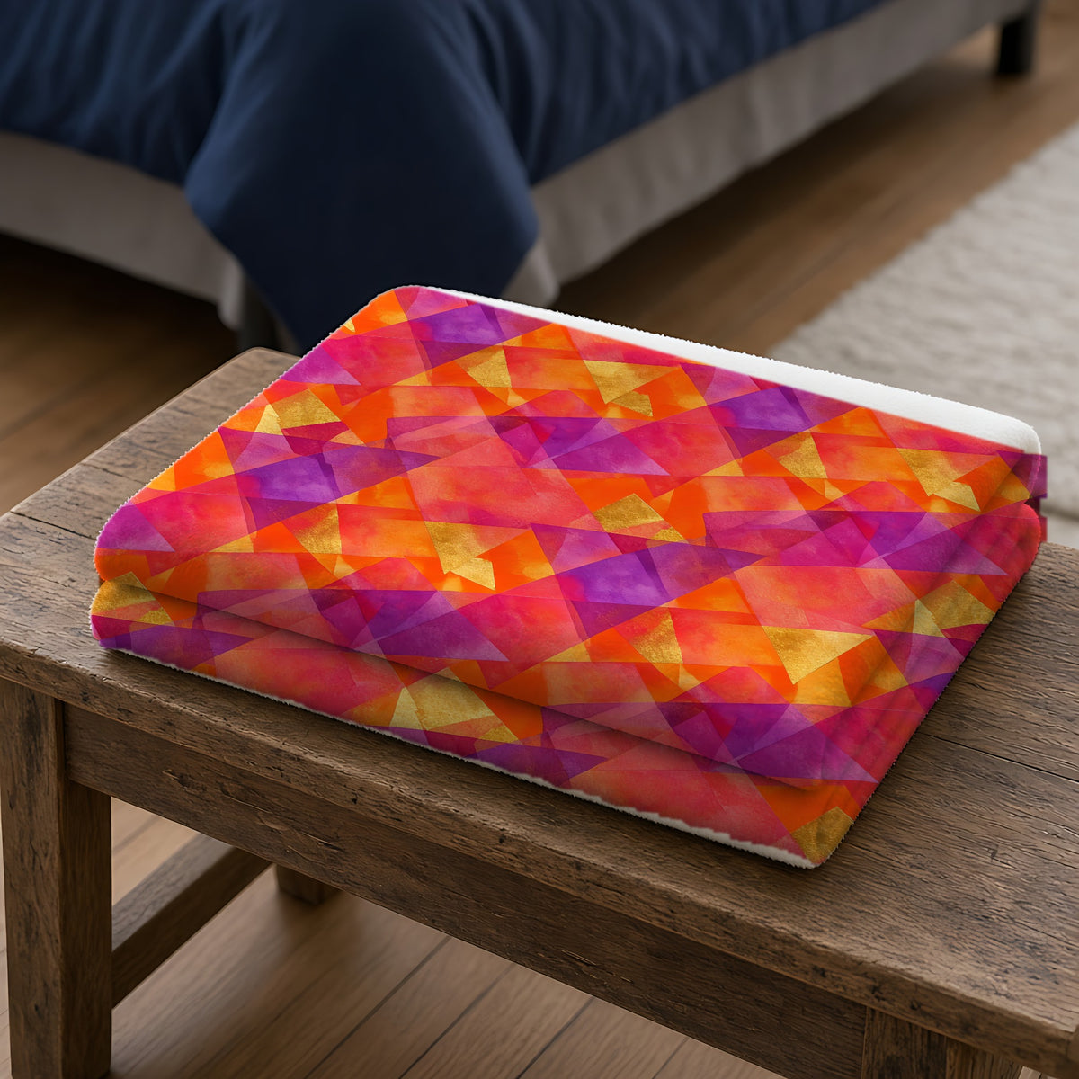 Layered Wash Shards Sherpa Fleece Blanket folded on a wooden bench