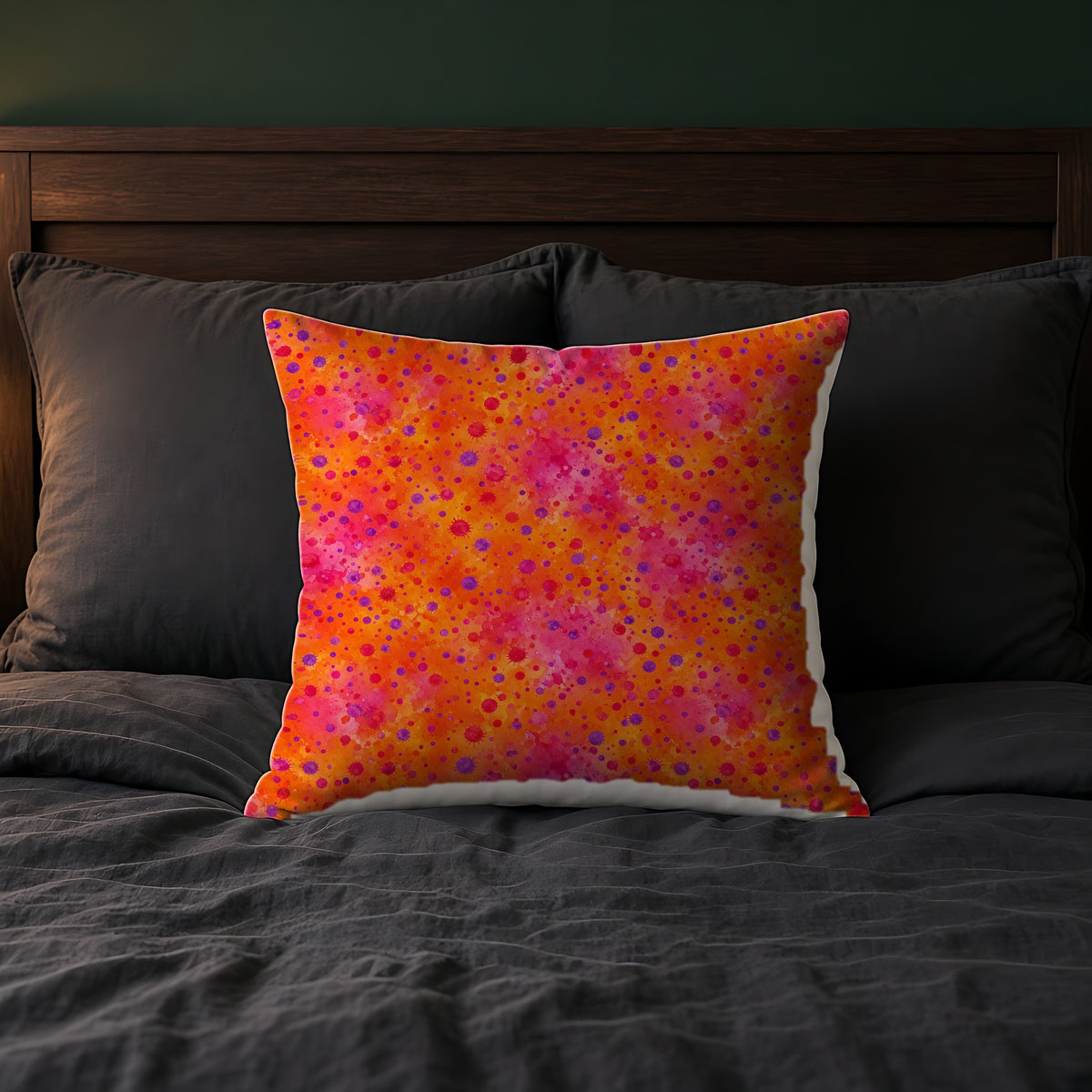 Pigment Dot Bleeds Faux Suede Cushion on a bed with charcoal bedding