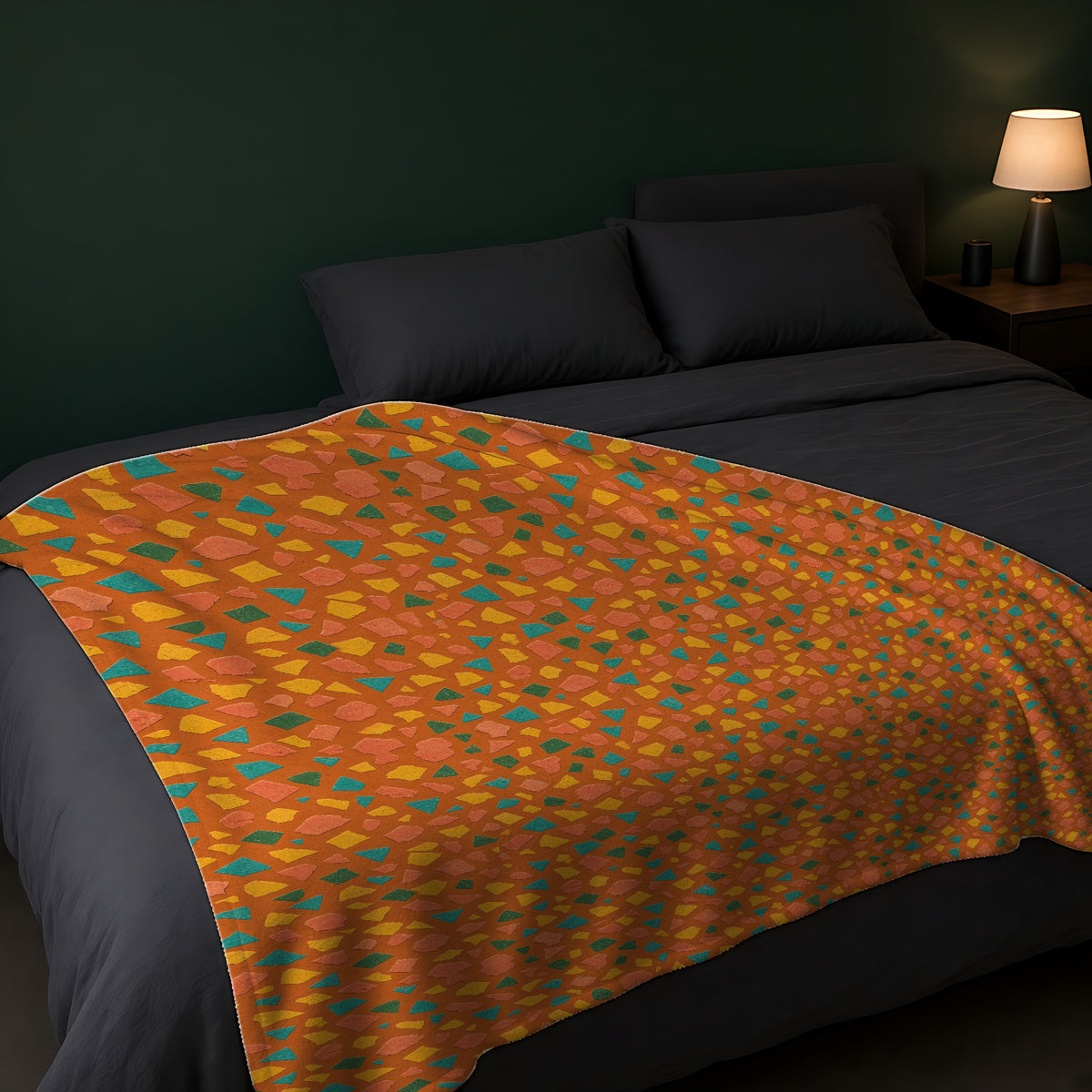 Angular Shard Scatter Sherpa Fleece Blanket across the foot of a dark bed