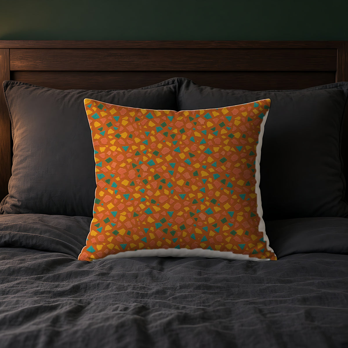 Angular Shard Scatter Faux Suede Cushion on a bed with charcoal bedding