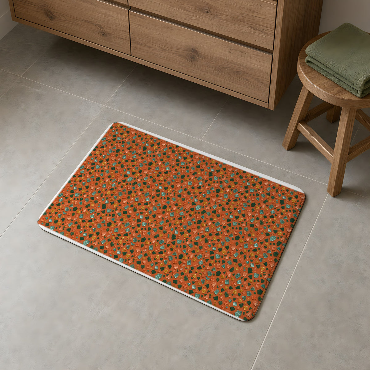 Glass Chip Sheen Bath Mat on a grey tiled bathroom floor