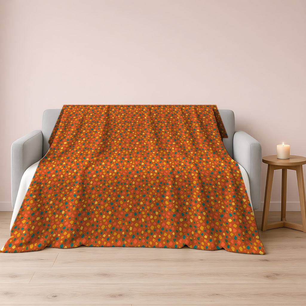 Confetti Aggregate Sherpa Fleece Blanket draped over a grey sofa