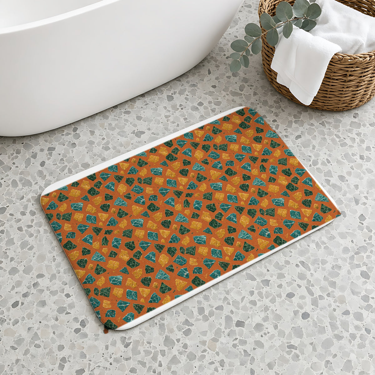 Marble Fragment Toss Bath Mat on a terrazzo floor beside a freestanding bath