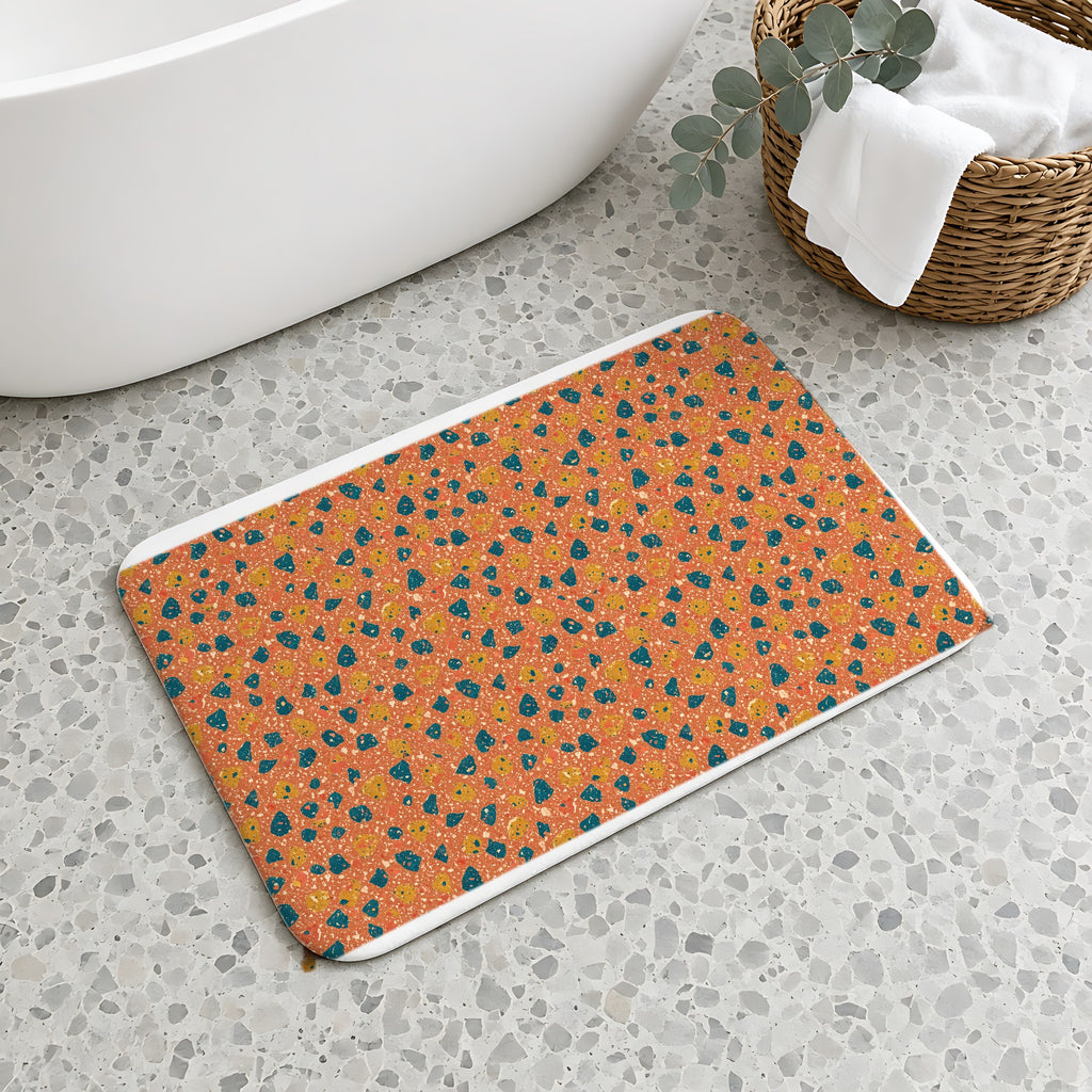 Two-Scale Chips Bath Mat on a terrazzo floor beside a freestanding bath