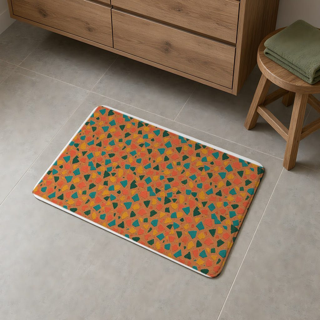 Shattered Tile Shards Bath Mat on a grey tiled bathroom floor