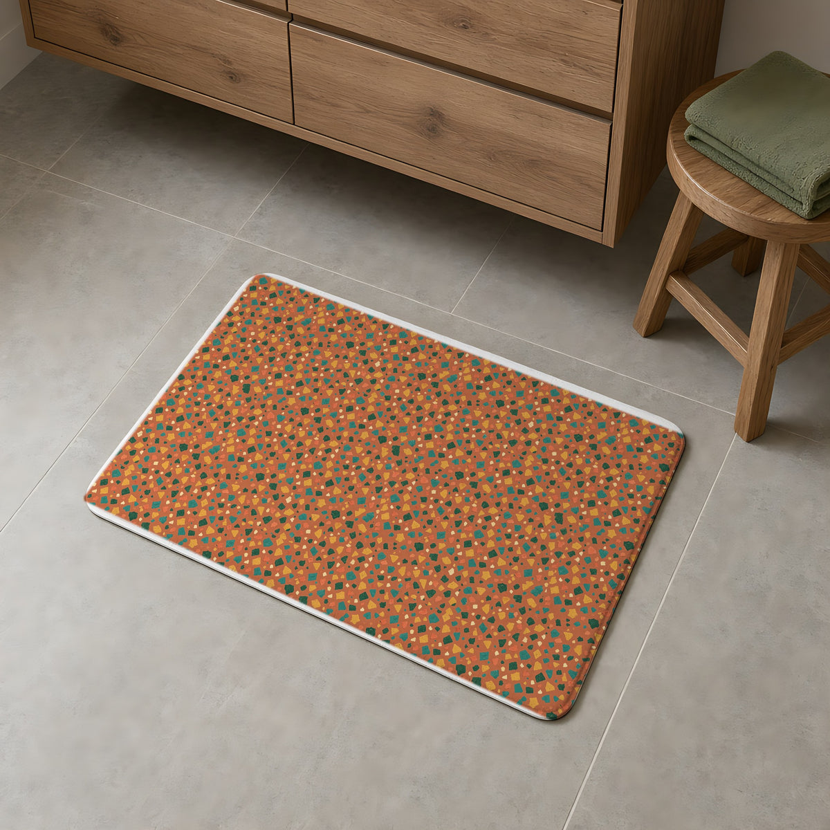Jewel Chip Terrazzo Bath Mat on a grey tiled bathroom floor