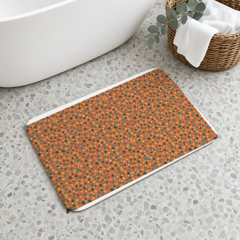 Jewel Chip Terrazzo Bath Mat on a terrazzo floor beside a freestanding bath