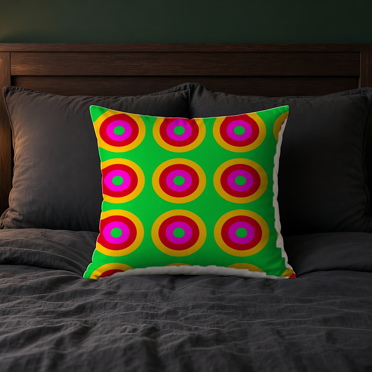 Giant Op-Art Jewel Rings Faux Suede Cushion on a bed with charcoal bedding