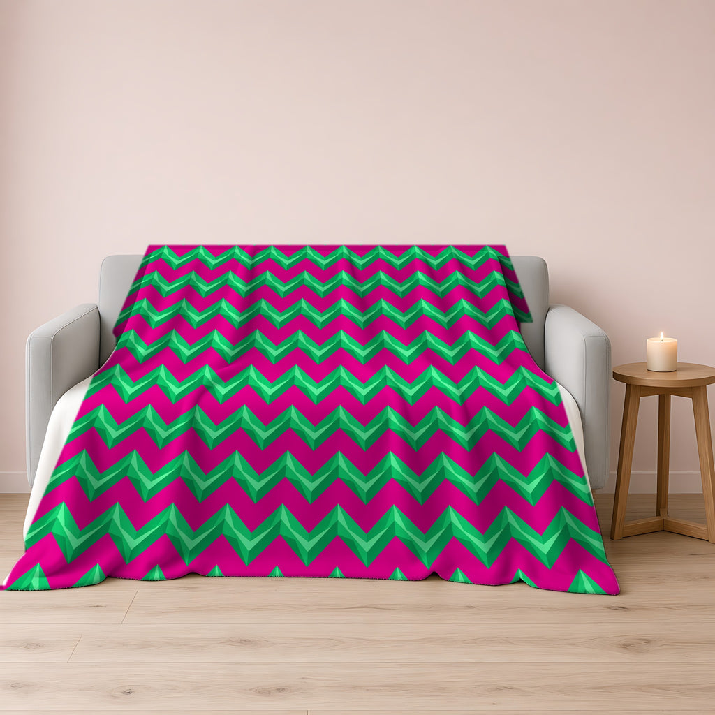 Broad Cut-Gem Chevrons Sherpa Fleece Blanket draped over a grey sofa