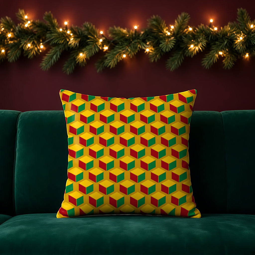 Giant Faceted Cubes II faux suede cushion in the Christmas Jewel Bright palette, on an emerald sofa in a festive room with a garland and fairy lights