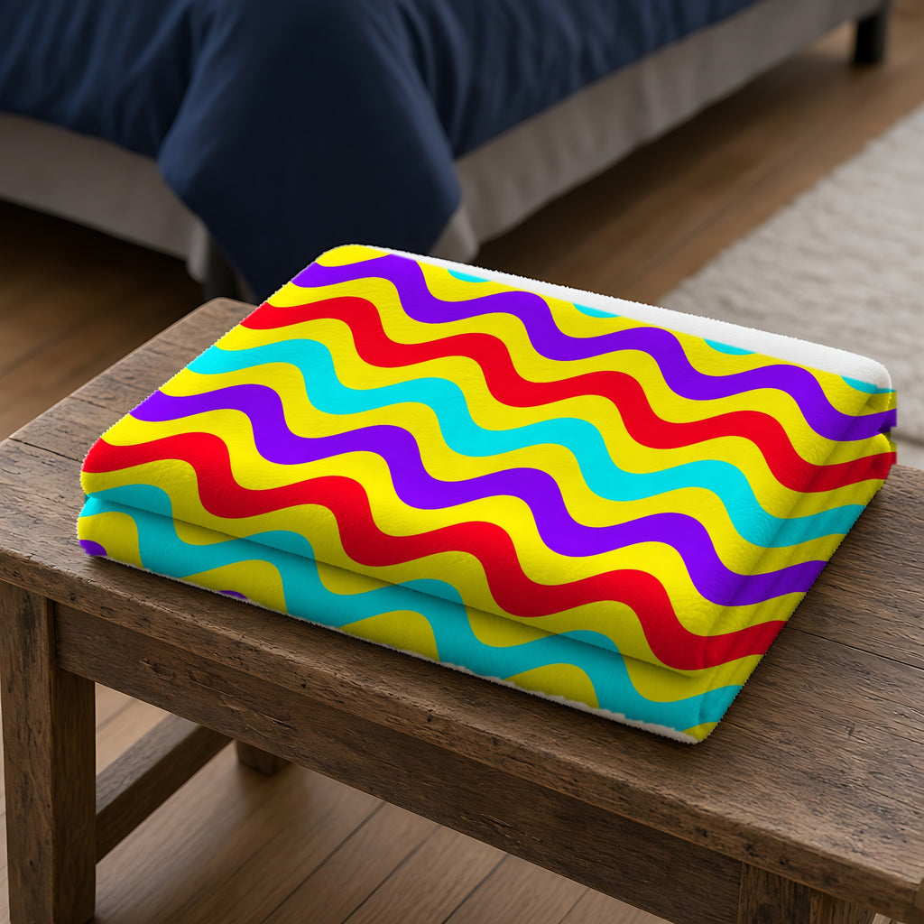 Big Ripple Chevrons Sherpa Fleece Blanket folded on a wooden bench