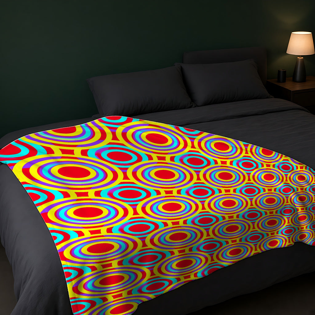 Interlocking Ring Ripples Sherpa Fleece Blanket across the foot of a dark bed