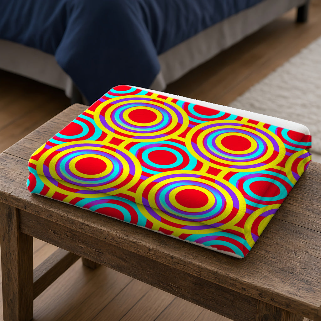 Interlocking Ring Ripples Sherpa Fleece Blanket folded on a wooden bench