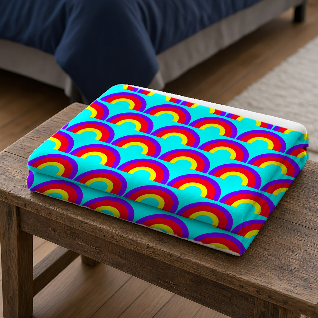 Chromatic Scallop Ripple Sherpa Fleece Blanket folded on a wooden bench