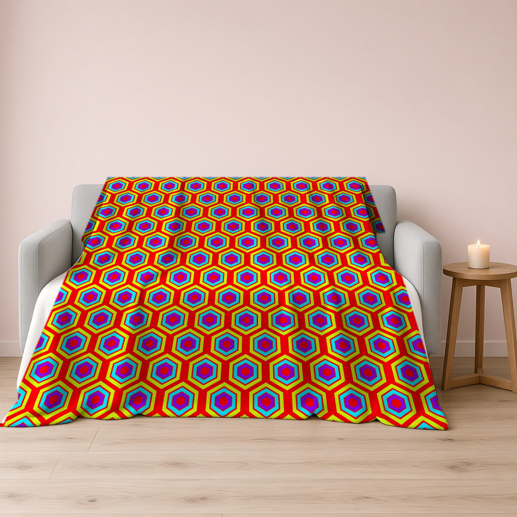Concentric Hexagon Ripple Sherpa Fleece Blanket draped over a grey sofa