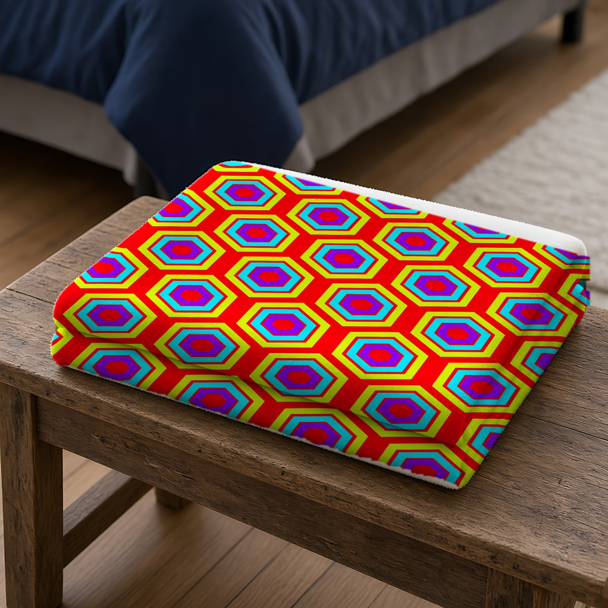 Concentric Hexagon Ripple Sherpa Fleece Blanket folded on a wooden bench