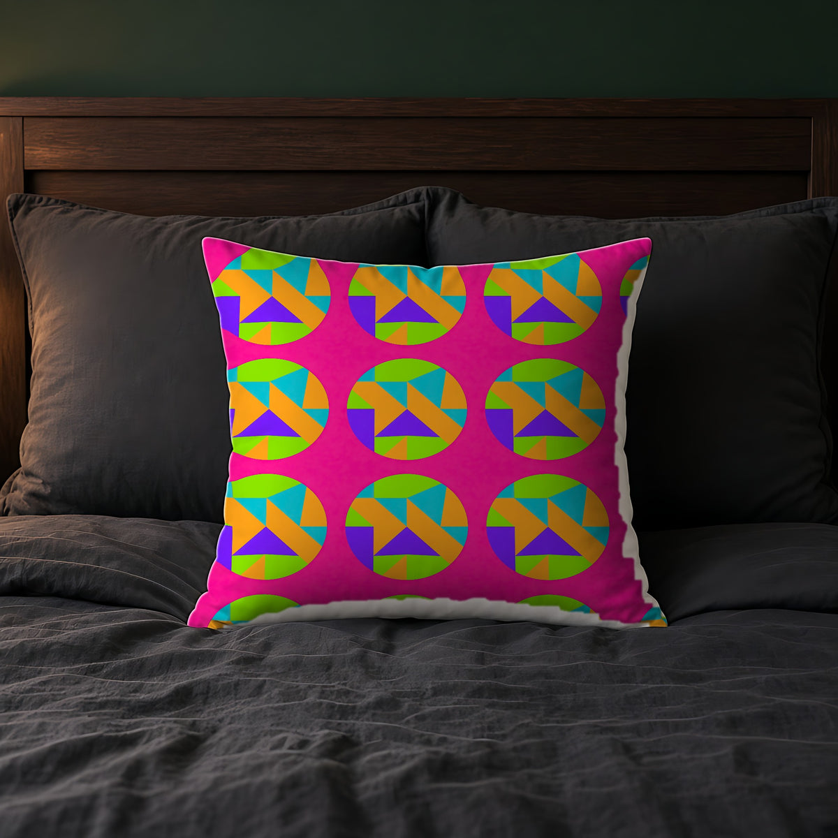 Broken Circle Planes Faux Suede Cushion in Tropical Punch on a bed with charcoal bedding