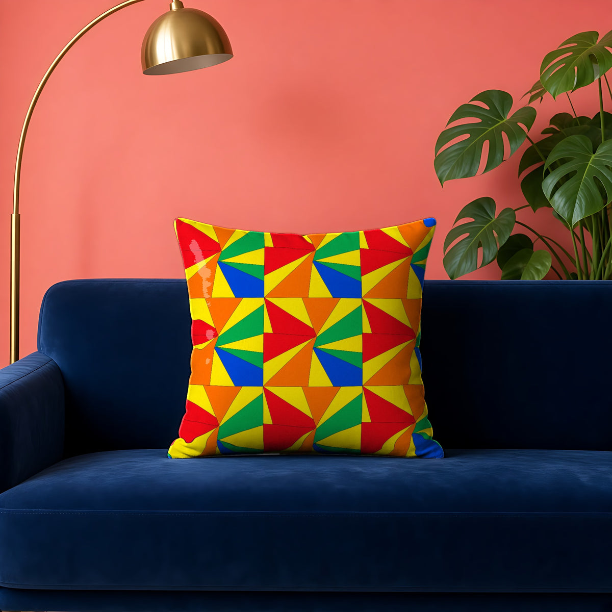 Cubist Sunburst Blocks faux suede cushion in the Cubist Carnival palette, on a navy velvet sofa against a coral wall