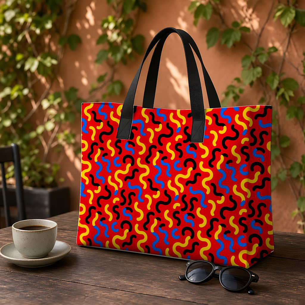 Squiggle Red Weekender Tote Bag on a garden café table