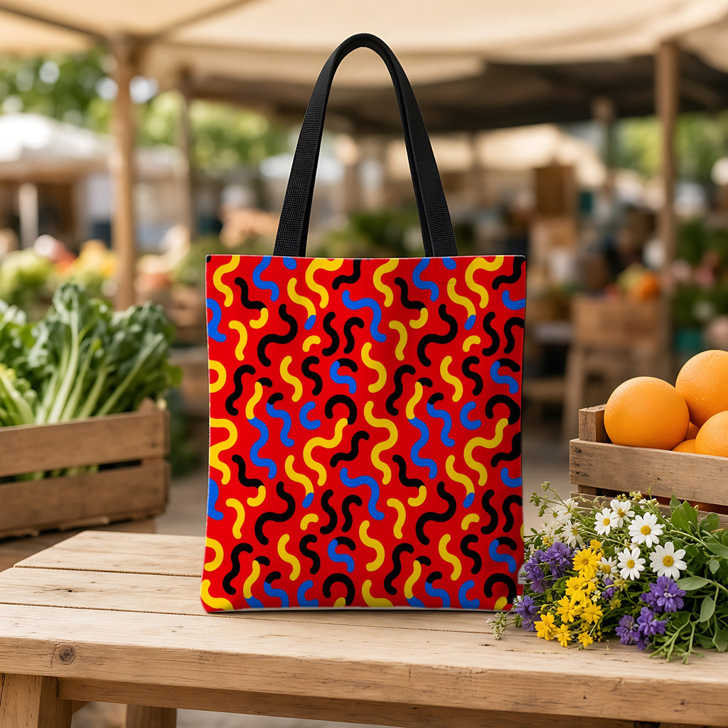 Squiggle Red Weekender Tote Bag on a wooden bench at a farmers market
